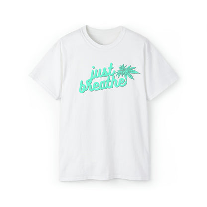 White T-shirt with teal "just breathe" text and a cannabis leaf design on the front, perfect for relaxation. This Just Breathe Cannabis Tee is a must-have addition to your wardrobe.