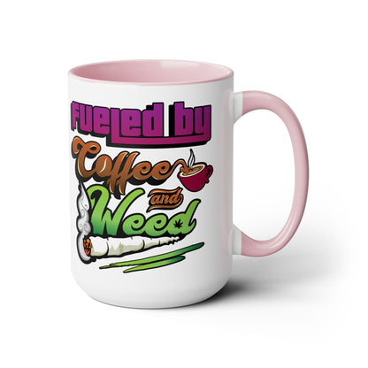 The Fueled by Coffee and Weed 15oz Coffee Mug is a white and pink ceramic mug featuring coffee cup, joint, and green leaf illustrations with the phrase "Fueled by Coffee and Weed.