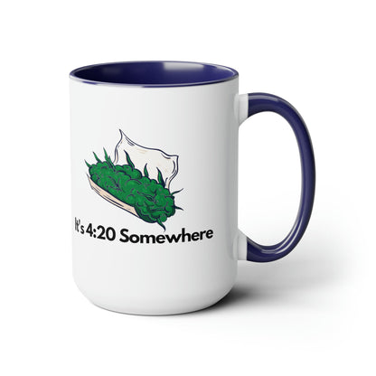 The "It's 420 Somewhere" 15oz Coffee Mug showcases a white ceramic body paired with a vibrant blue handle