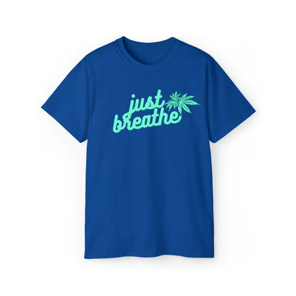 A blue Just Breathe Cannabis Tee featuring the words "just breathe" and an image of a cannabis leaf in light green text, perfect for those promoting relaxation.