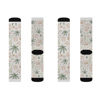Retro Weed Socks: four white socks with black accents, decorated with green cannabis leaves and brown snack foods in a repeating pattern—an ideal 420 gift for any cannabis enthusiast.