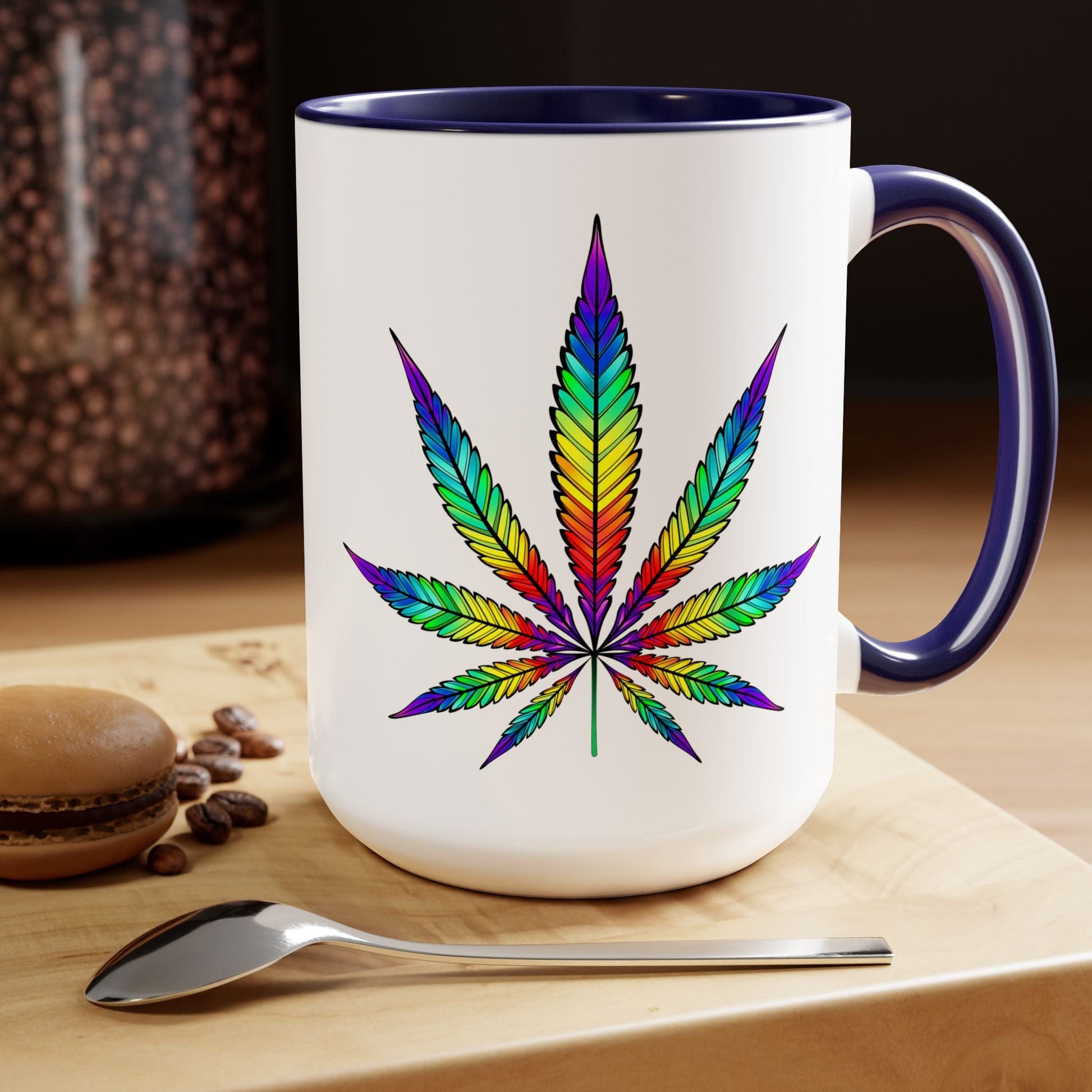 A white ceramic Vibrant Rainbow Cannabis Mug with a rainbow-colored cannabis leaf design 