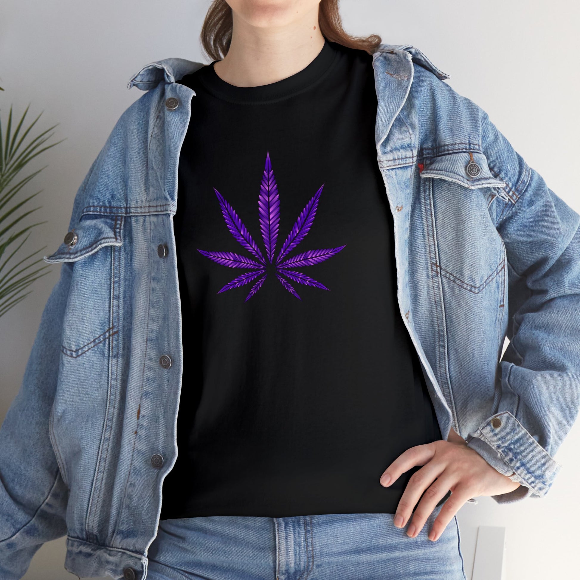 A person wearing a black t-shirt with a vibrant Purple Cannabis Leaf Tee design, layered under an open denim jacket.