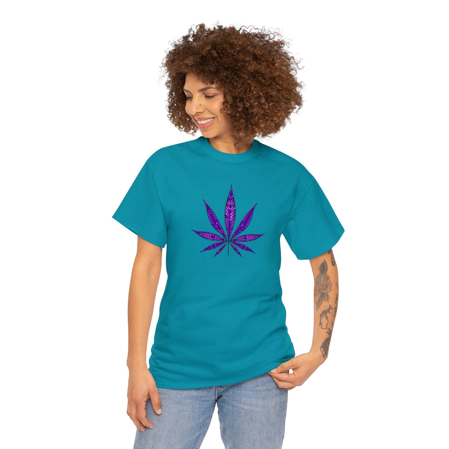 A woman wearing a vibrant color teal t-shirt with a Purple Cannabis Leaf Tee design on the front, representing marijuana culture.