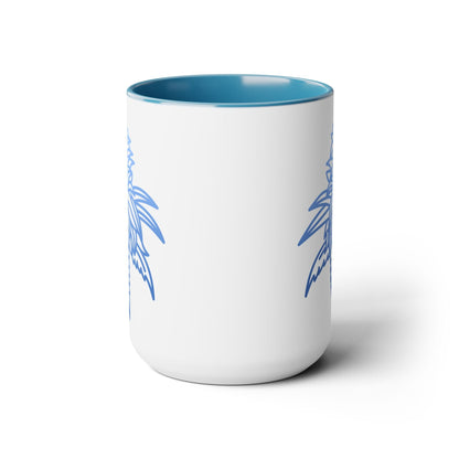 The Blue Dream Cannabis Coffee Mug is a white ceramic mug with a blue interior and partial blue palm tree designs