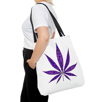 Person holding a Purple Haze Marijuana Tote Bag, which is both durable and spacious, featuring a purple cannabis leaf design, while wearing a white t-shirt and black pants.