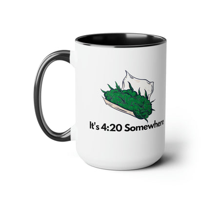 This 15oz coffee mug, titled "It's 420 Somewhere," features a sleek black handle and displays a graphic of cannabis leaves