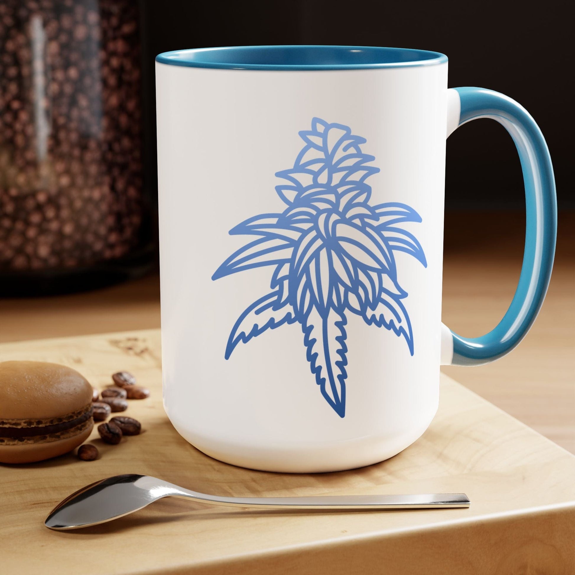 A Blue Dream Cannabis Coffee Mug with a blue interior and handle sits on a table.