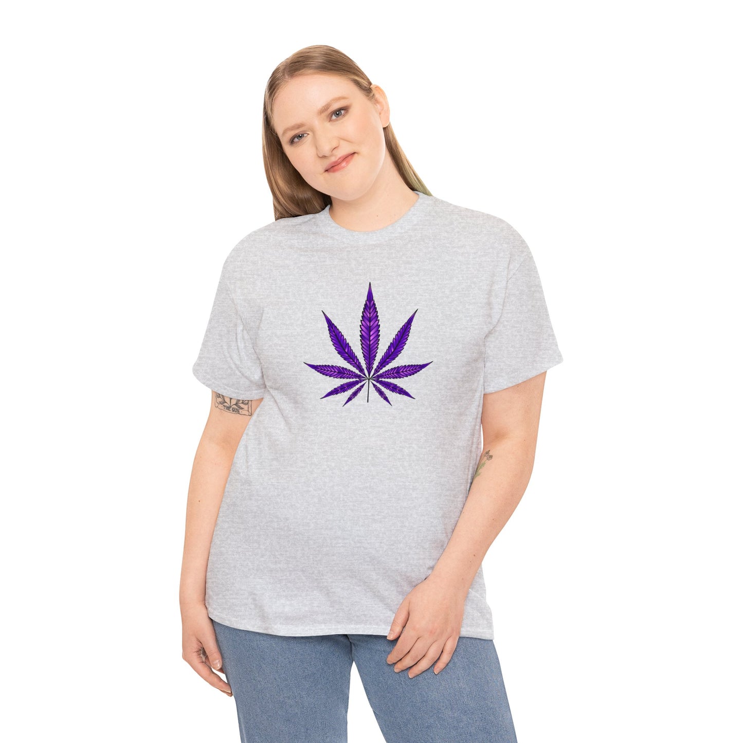 A woman wearing a grey t-shirt with a vibrant Purple Cannabis Leaf Tee design on the front, symbolizing marijuana culture.