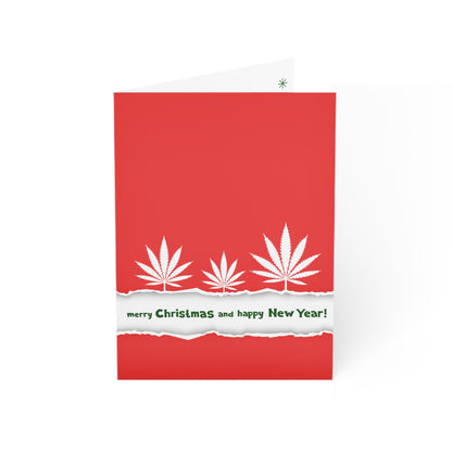 Red Have a Dope Holiday Merry Christmas Happy New Year greeting card crafted from sustainable paper with a torn edge revealing "merry christmas and happy new year!" text, and cannabis leaves instead of traditional Christmas symbols.