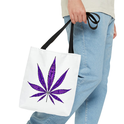 Person holding a Purple Haze Marijuana Tote Bag adorned with a purple cannabis leaf design.