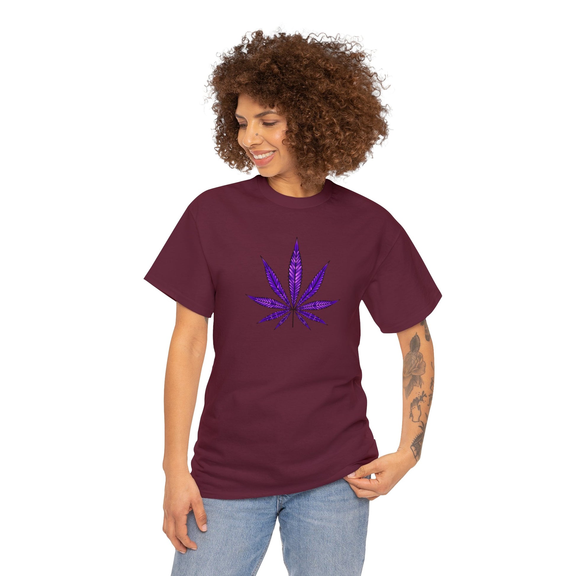 A woman wearing a vibrant color t-shirt with a Purple Cannabis Leaf Tee on the front, representing marijuana culture.