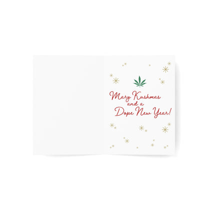 Inside of a white greeting card with the message 'Merry Kushmas and a Dope New Year!', decorated with a cannabis leaf icon and golden snowflakes, creating a playful holiday sentiment.