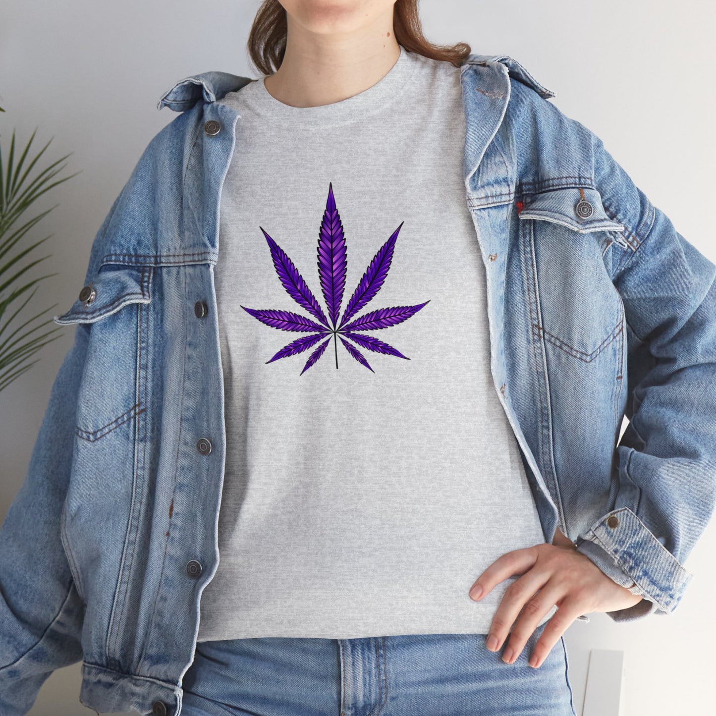 A person wearing a denim jacket over a vibrant color "Purple Cannabis Leaf Tee", embracing the marijuana culture.