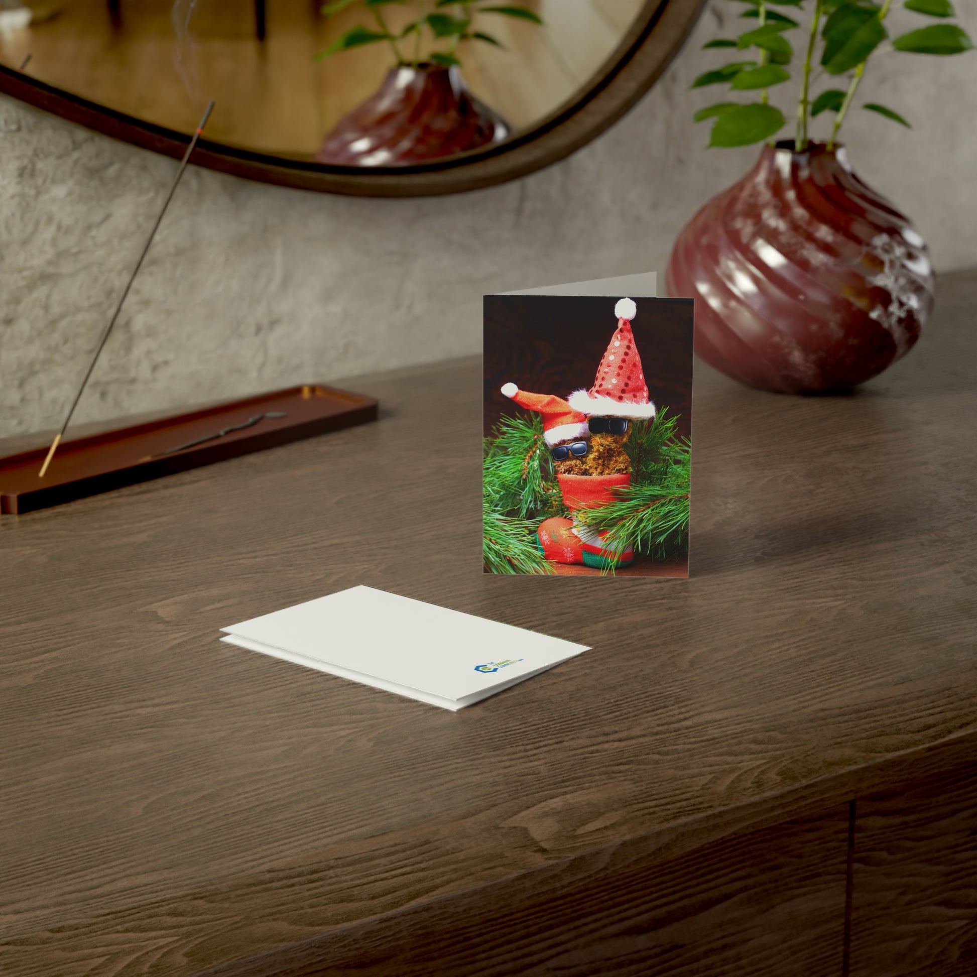 Front view and back view of Marijuana themed greeting card on a table with incense burning 
