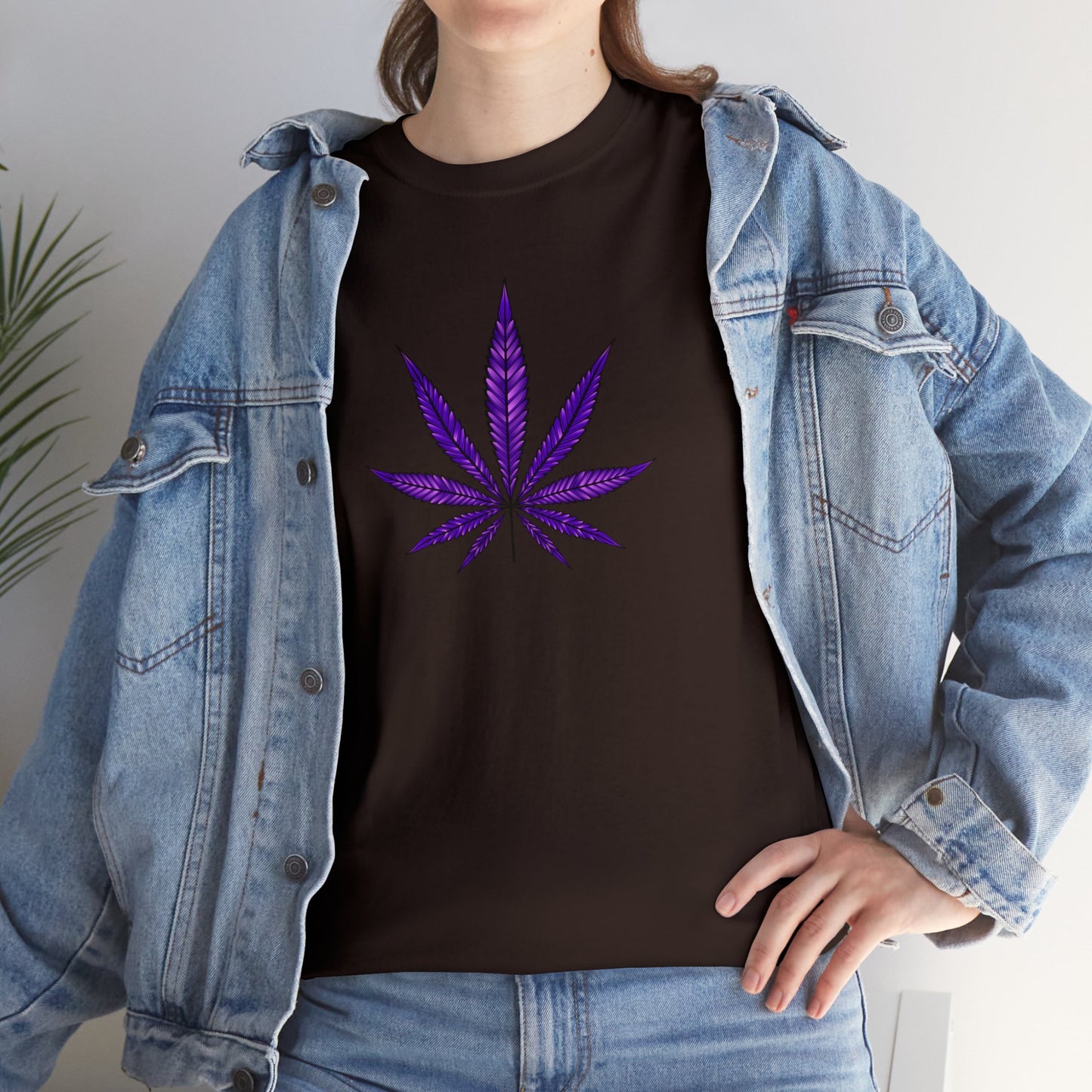 A person wearing a Purple Cannabis Leaf Tee with a purple cannabis leaf design, layered with an open denim jacket, standing against a neutral background.