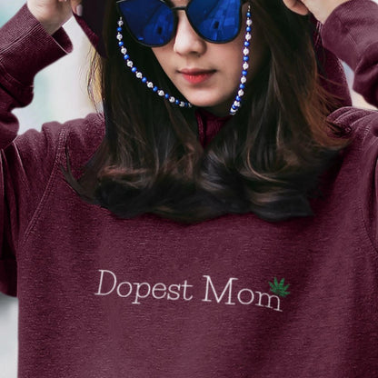  Woman Wearing Dopest Mom Pot Leaf  Hoodie wearing sunglasses