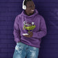 Smiling Black man Leaning against dark purple brick wall wearing a Team Indica light purple cannabis hoodie