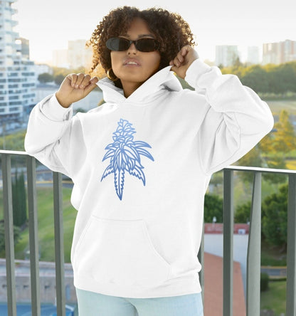 A person with curly hair, wearing sunglasses and a white Blue Dream Cannabis Hoodie, stands on a balcony against the backdrop of a cityscape, radiating both comfort and style.