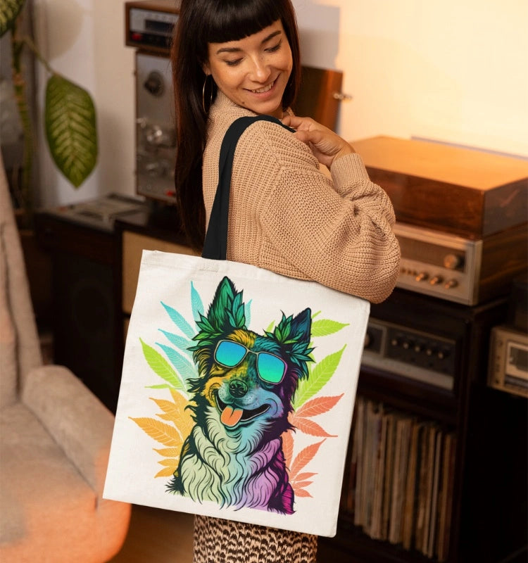 A woman with long dark hair smiles while carrying a Cool Border Collie Weed Tote Bag, which features a colorful illustration of a dog wearing sunglasses, in a retro-styled room.