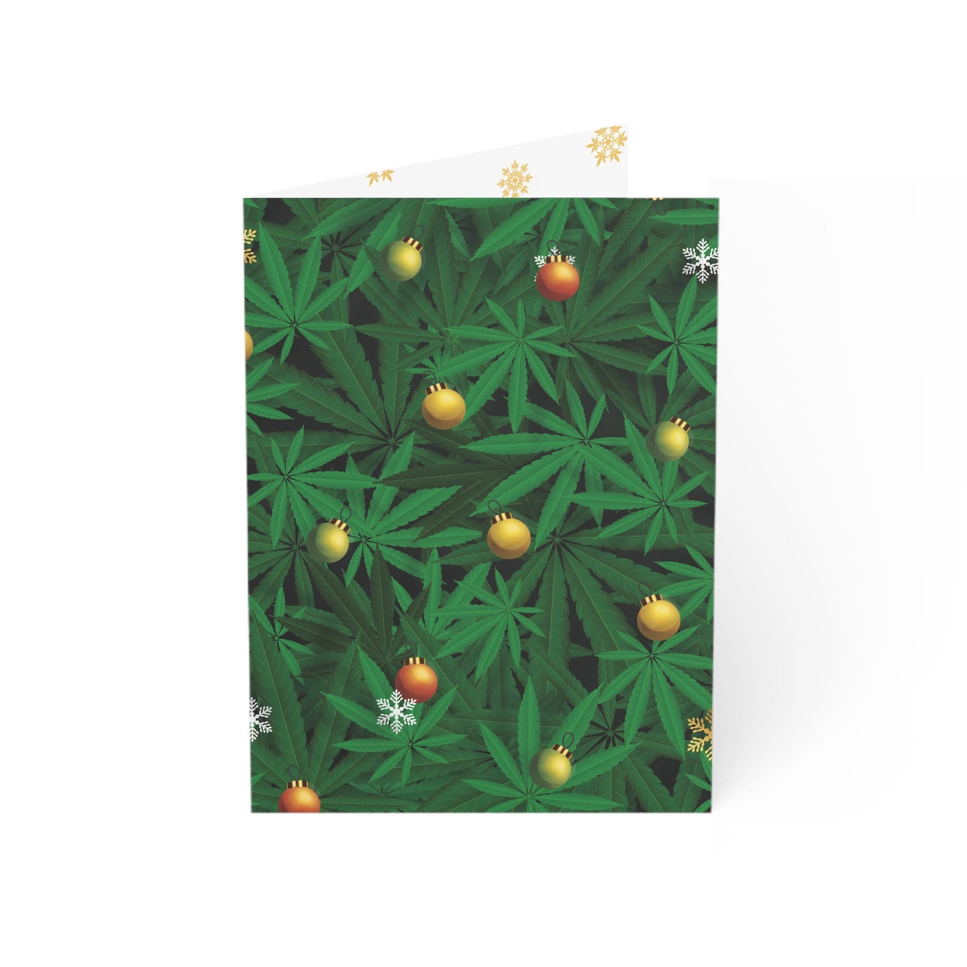 A Christmas card mockup partially unfolded, showing a design of green cannabis leaves with festive ornaments on the right and a blank white interior on the left.