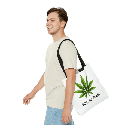 A person smiles while walking, holding the Free The Plant Marijuana Tote Bag