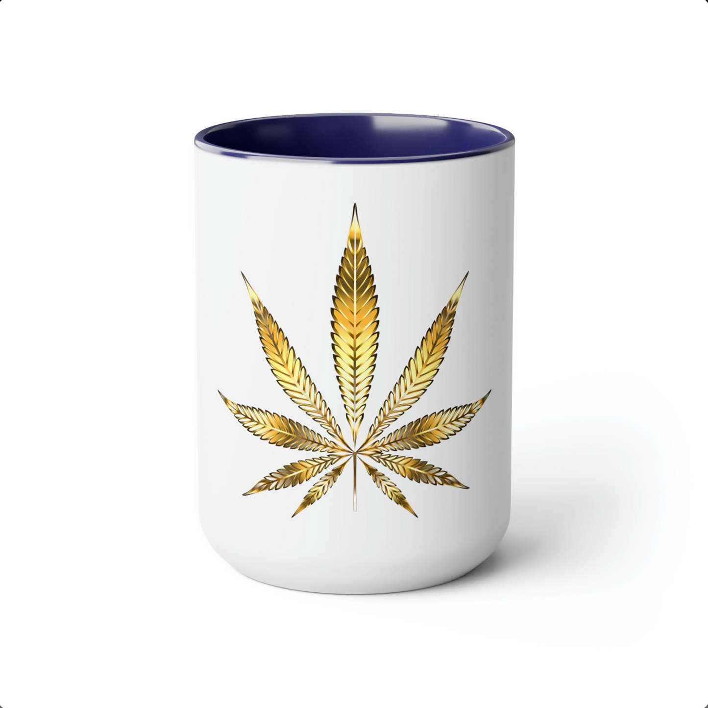 A white cannabis mug with a navy blue interior featuring a bright gold weed leaf on the front center.