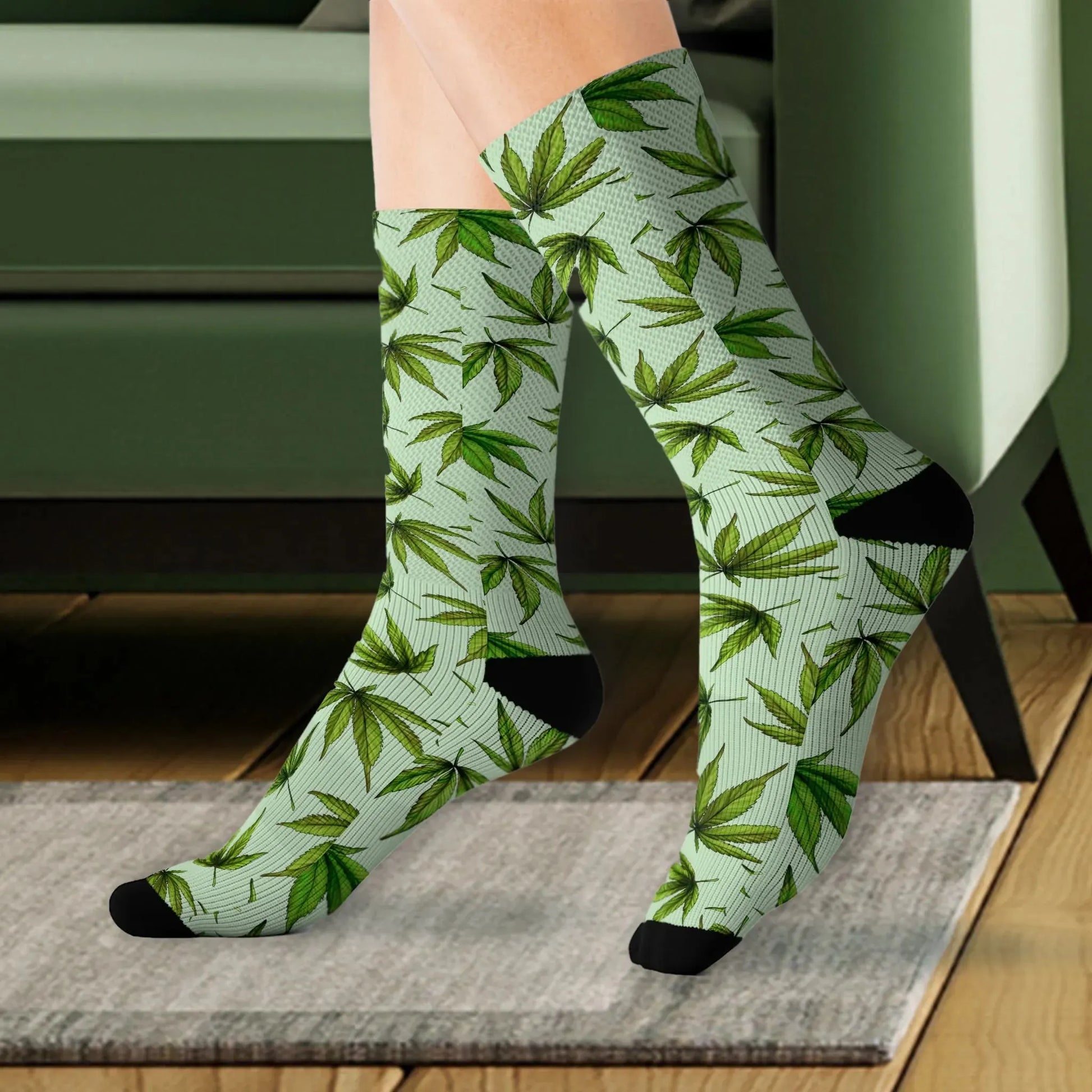 A close up of a person wearing green marijuana leaf weed socks on a rug
