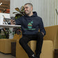 Man sitting on a yellow chair playing on his phone wearing a Let's Get Baked phrase and cupcake graphic with marijuana leaf pick hoodie