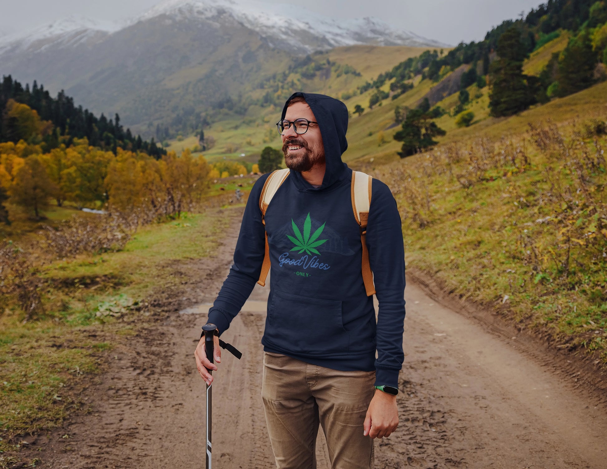 Black man hiking the mountains wearing a Good Vibes Only Marijuana Mountain Navy Blue Hoodie
