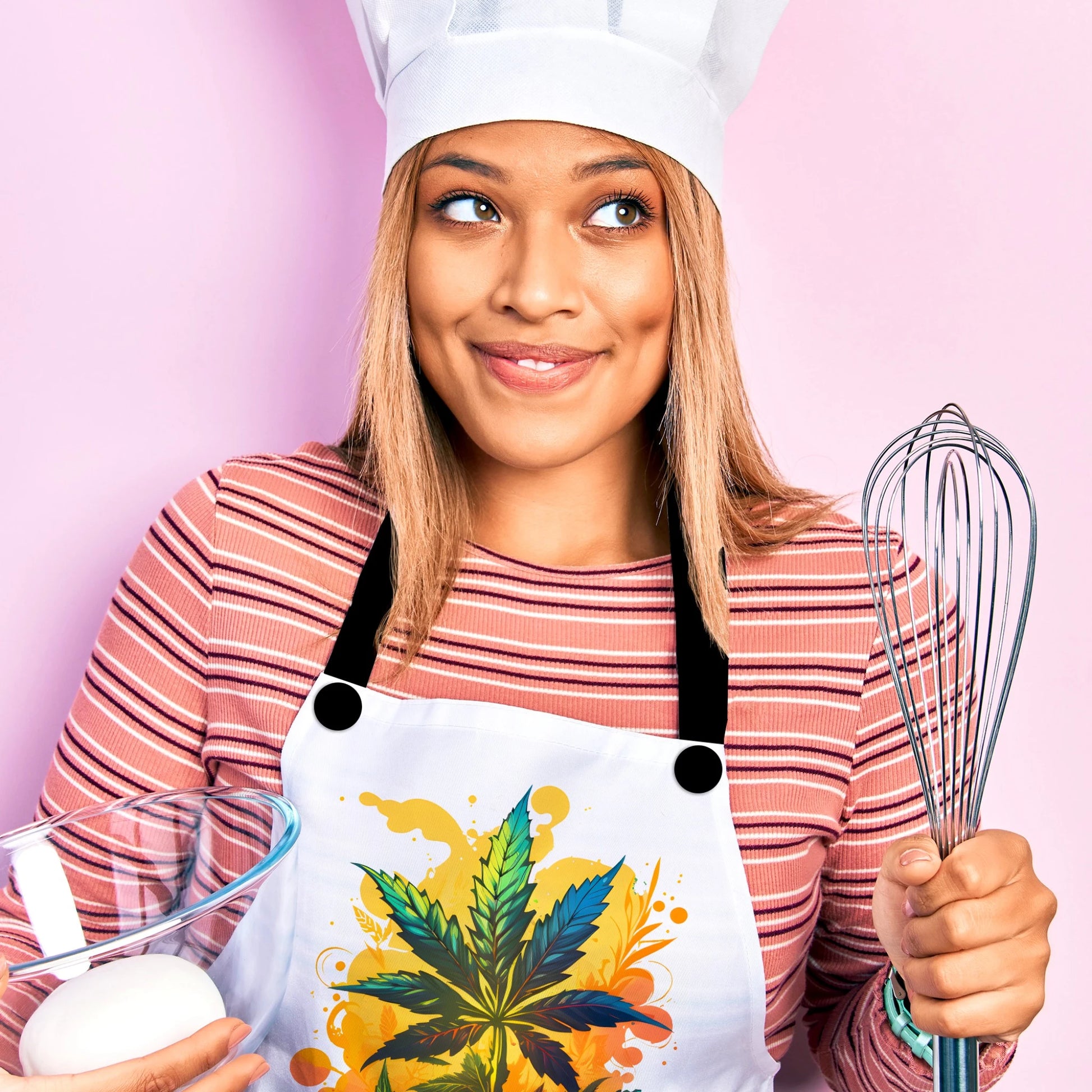 a woman is wearing a warm weed paradise baking apron and a chef's hat while holding a whisk and bowl.