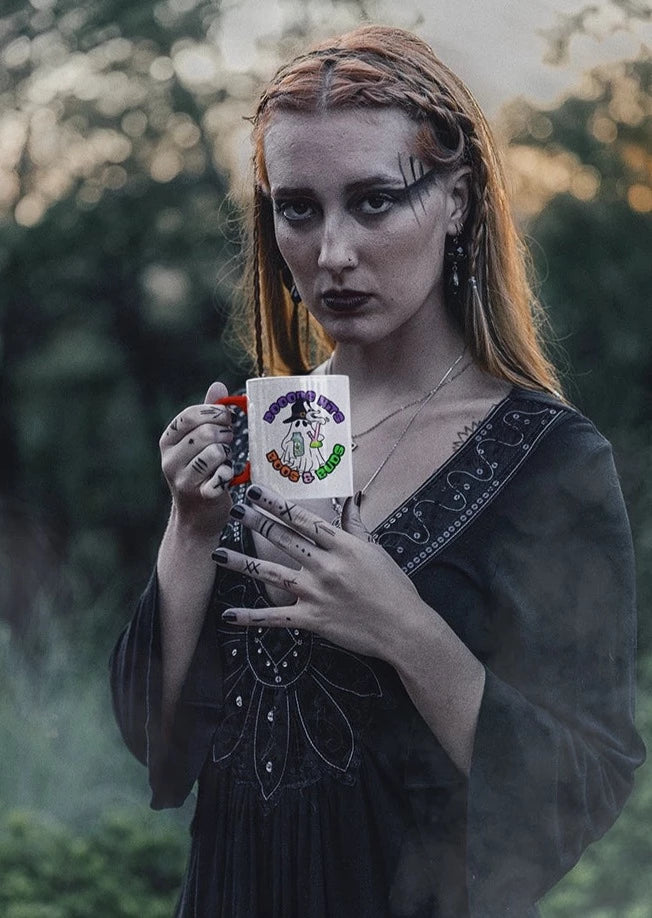 Wiccan Witch in the woods drinking from her Bong Boos and Buds coffee mug