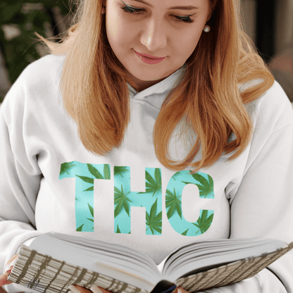 A person wearing a striking Women's Women's THC Leaf Hoodie