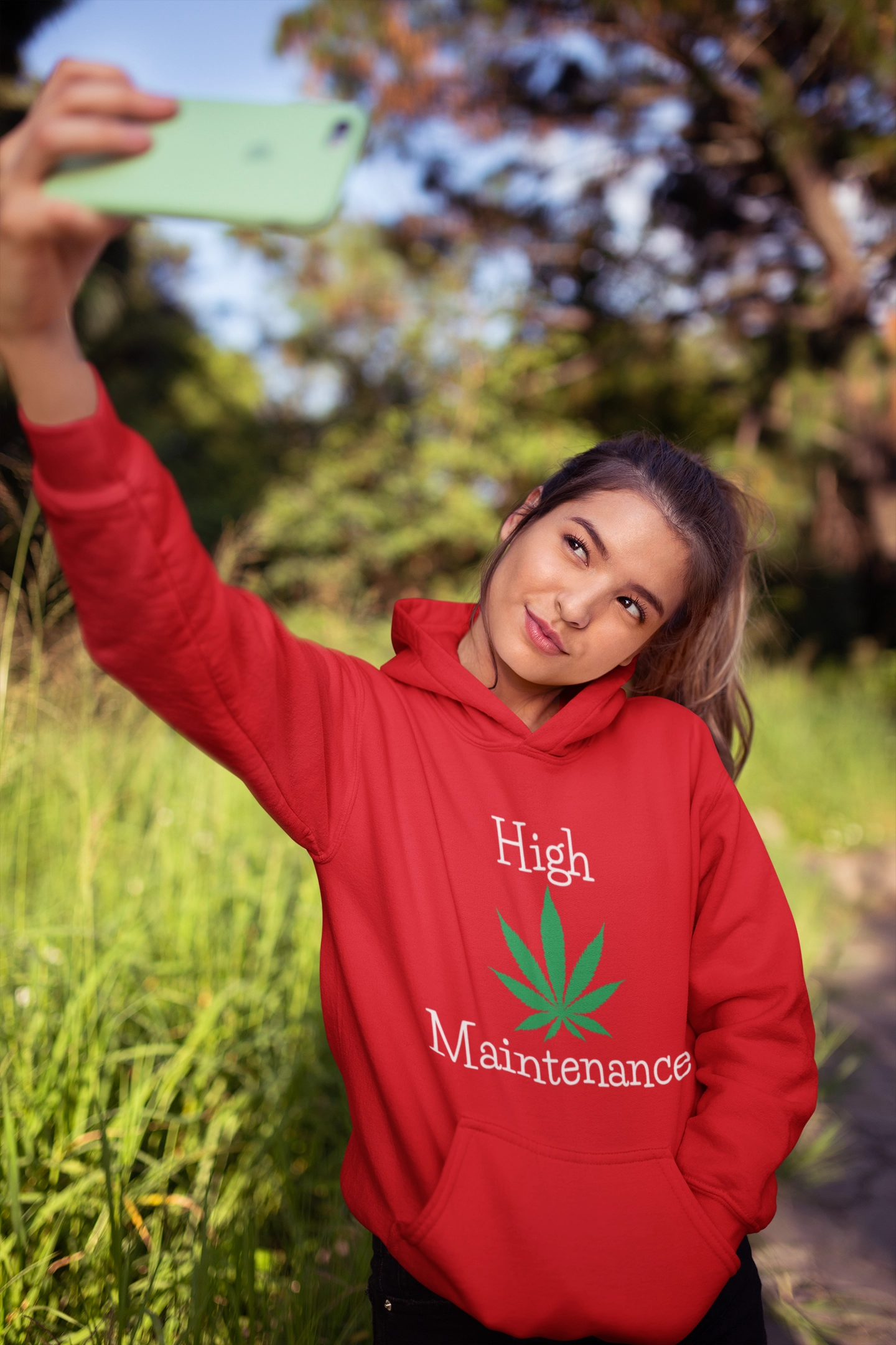 Woman taking a selfie Wearing High Maintenance Marijuana Leaf Red Hoodie outdoors