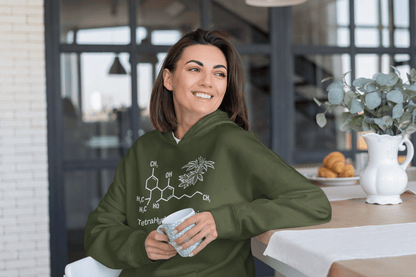 Woman sitting enjoying coffee wearing a THC cannabinoid Military Green Marijuana Hoodie