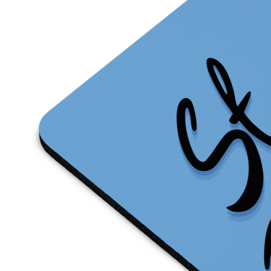 Close-up of a corner of a Stay Frosty Blue Mouse Pad with a black cursive design, showcasing the non-slip grip and texture detail.