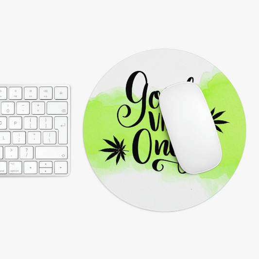 Non-Slip Neoprene computer mouse on a round Good Vibes Only Cannabis Mousepad with "good vibes only" text and green paint splashes, next to a white keyboard on a white surface.