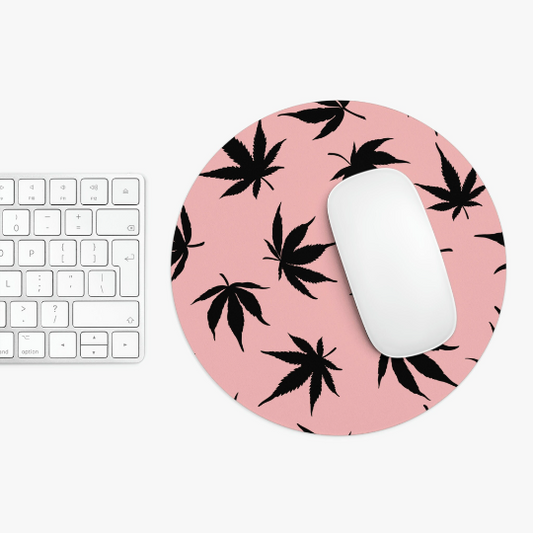 A white computer keyboard next to a Marijuana Leaves Pink Mouse Pad, holding a white computer mouse.