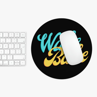 White computer Wake and Bake Cannabis mouse on a black non-slip mousepad with colorful "work hard" text, next to a white keyboard on a white surface.