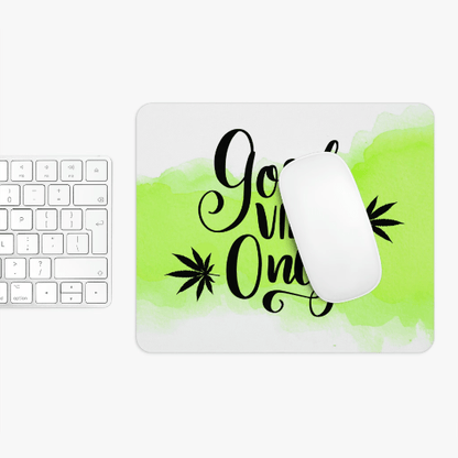 A white keyboard next to a non-slip neoprene Good Vibes Only Cannabis Mousepad with a green watercolor 