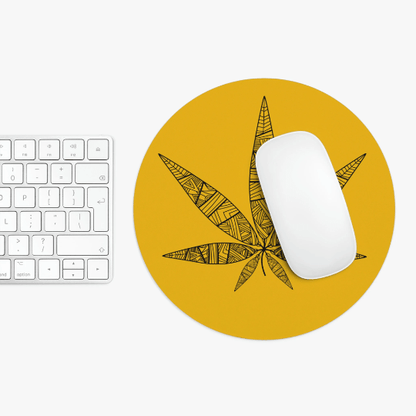 A keyboard and mouse rest on the Tribal Weed Leaf Yellow Mouse Pad, which features a vibrant yellow neoprene surface with a black geometric tribal weed leaf design.