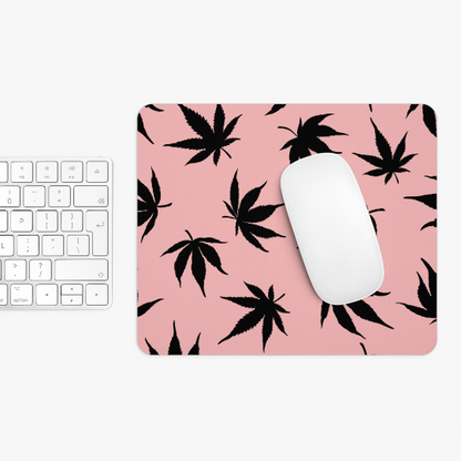 A white computer mouse and keyboard rest on a high-quality neoprene Marijuana Leaves Pink Mouse Pad.