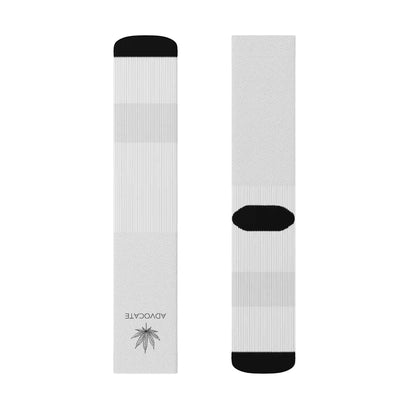 a pair of black and white Marijuana Socks that show a weed leaf on the top front of the sock with a word below it that reads "advocate"