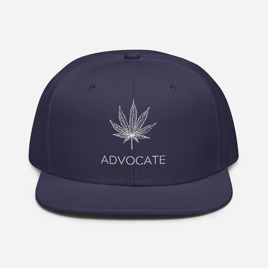 Elegant Advocate Cannabis Leaf Snapback Hat with a navy blue color and the word "advocate" embroidered on the front.