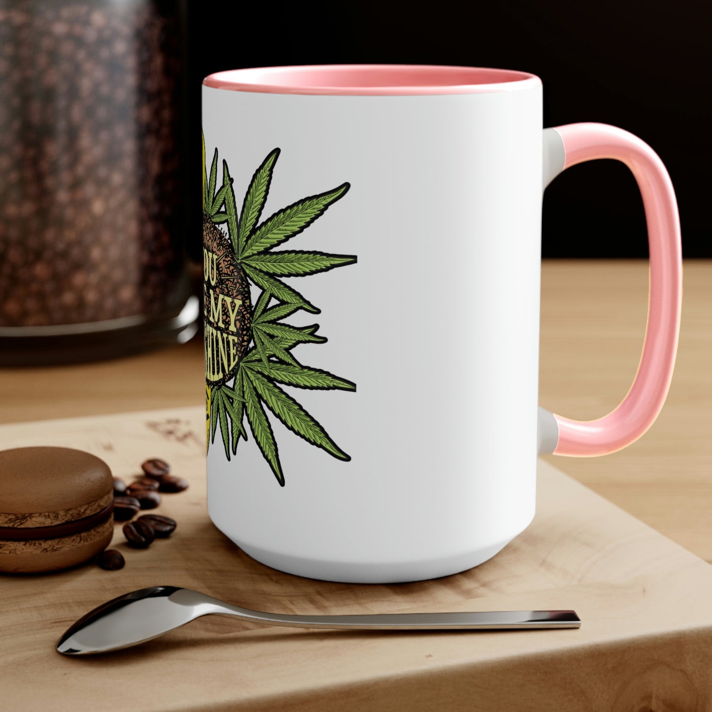 a You Are My Sunshine coffee mug with a marijuana leaf on it.