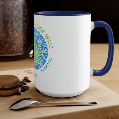 A Not High, Just Well Coffee Mug with a flower on it and a spoon next to it.