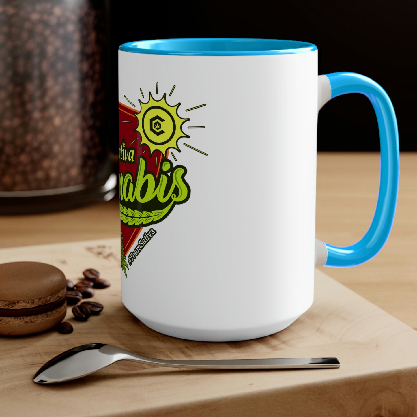 a Team Sativa Cannabis Coffee Mug with a heart on it and a spoon on it.