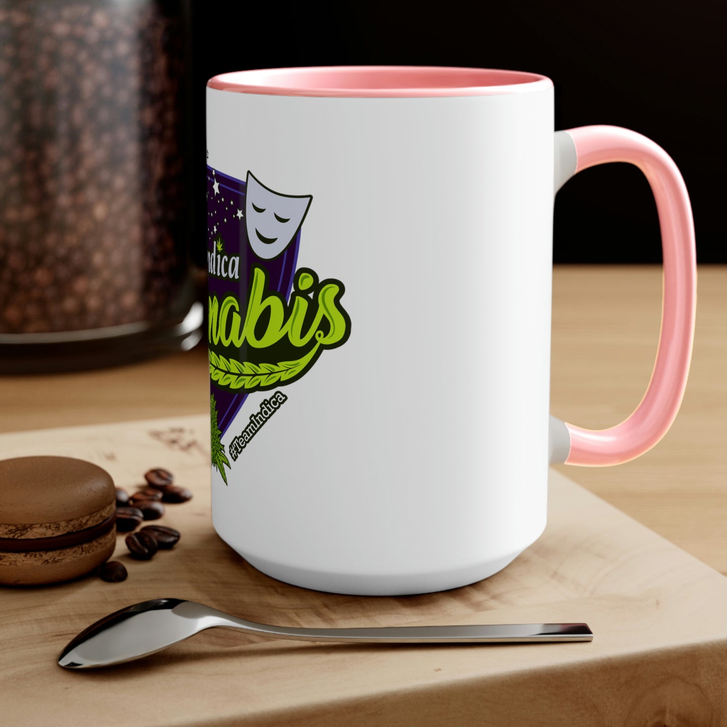 a Team Indica Cannabis Mug with a spoon and coffee beans on it.