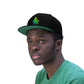 A young man wearing the all black Rainbow Sherbet Marijuana Snapback Hat with green underneath the bill