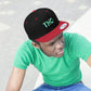 Red and black THC Snapback Hat with weed leaves being worn by a young man with a green t-shirt